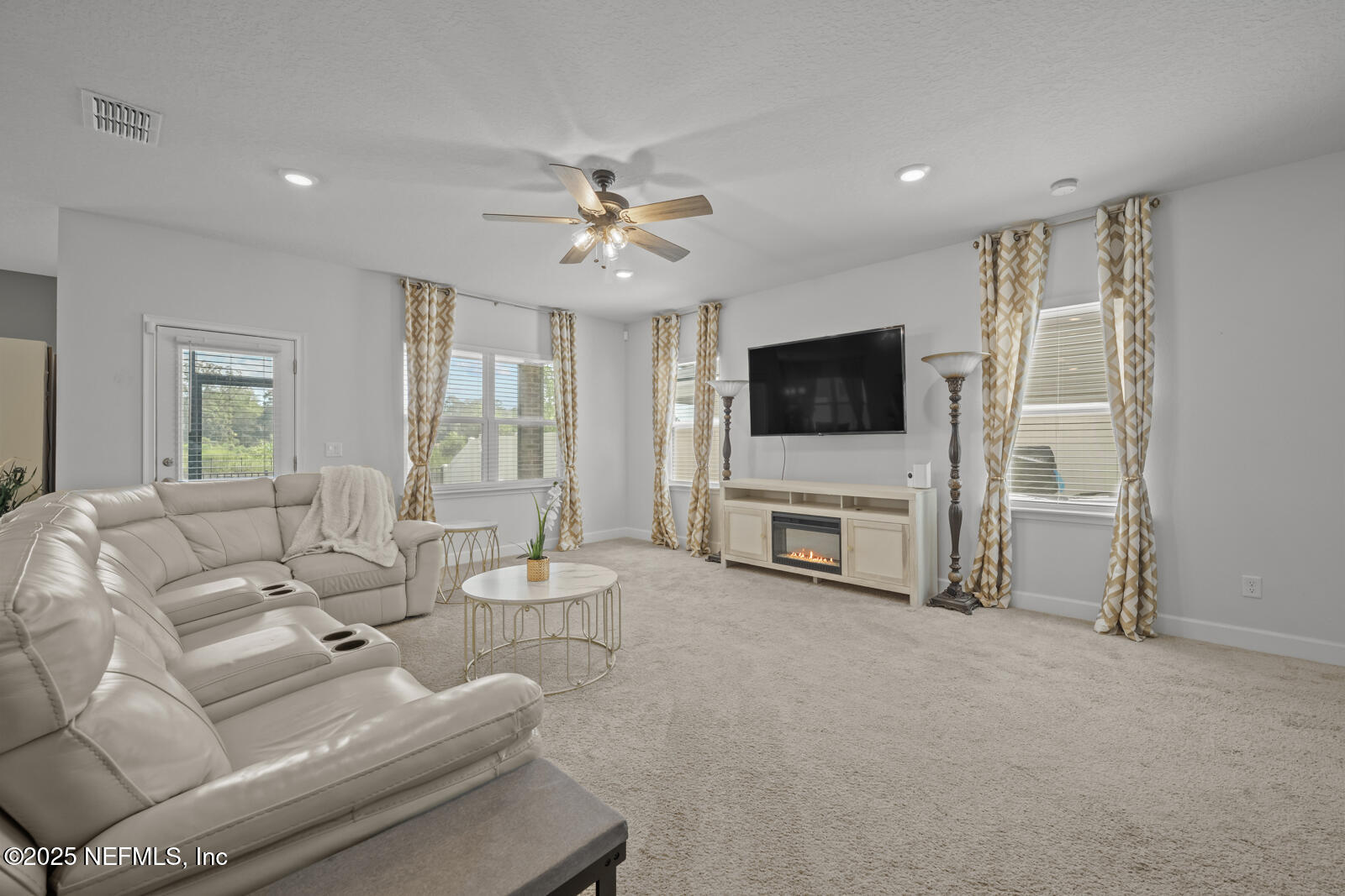 9961 Redfish Marsh Circle Jacksonville, FL 32219 - Photo 7 of 37 a living room with furniture and a flat screen tv