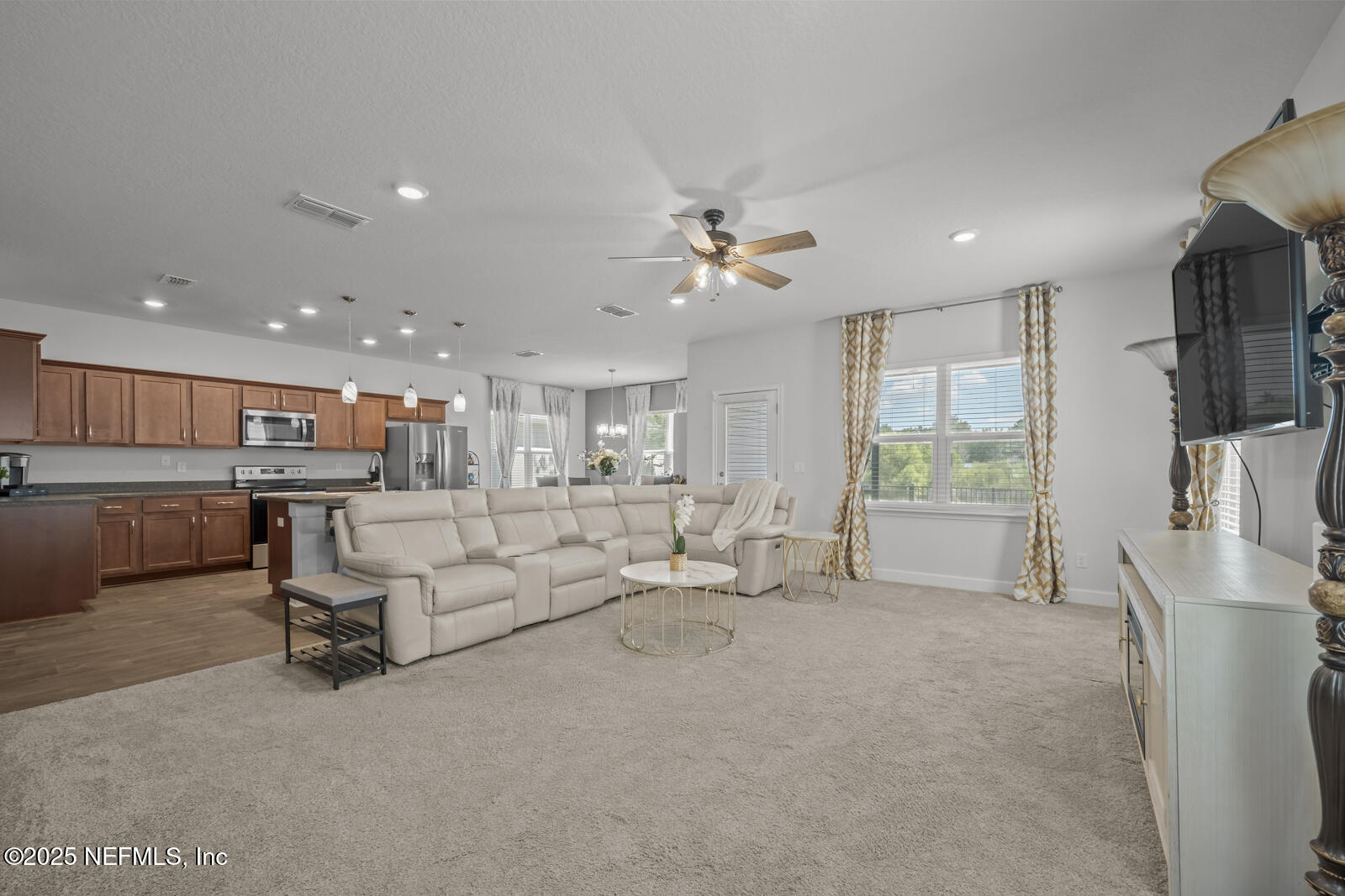 9961 Redfish Marsh Circle Jacksonville, FL 32219 - Photo 8 of 37 a living room with furniture and a flat screen tv