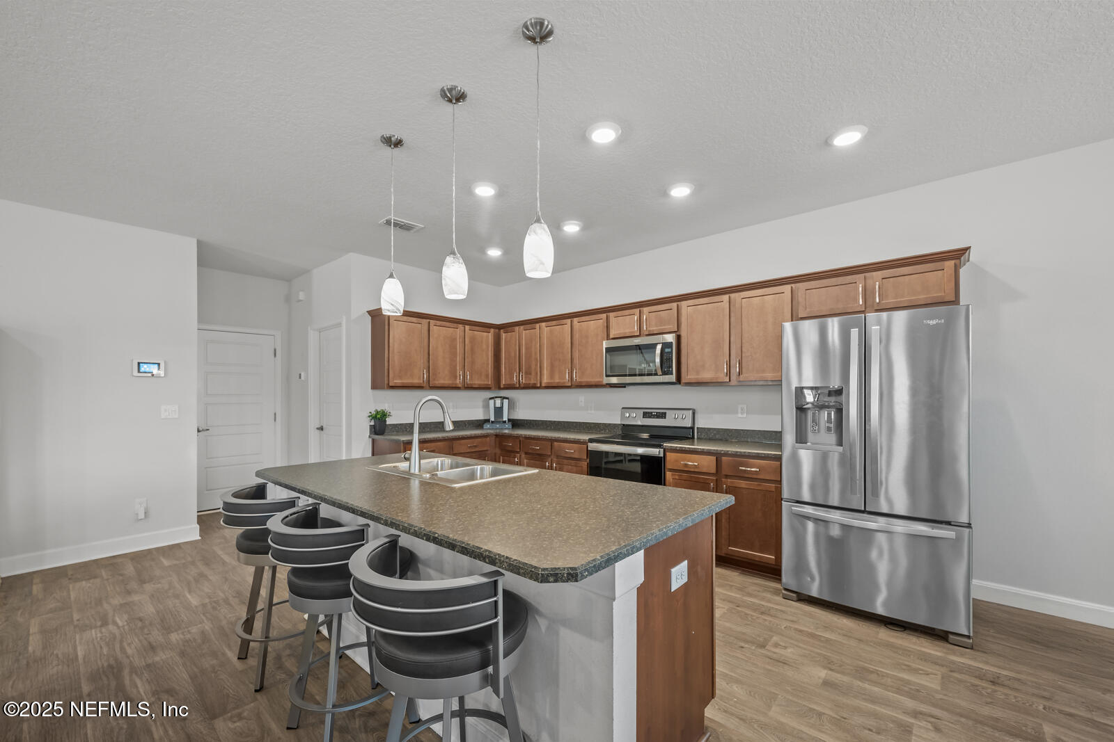 9961 Redfish Marsh Circle Jacksonville, FL 32219 - Photo 9 of 37 a kitchen with stainless steel appliances granite countertop a sink stove and refrigerator