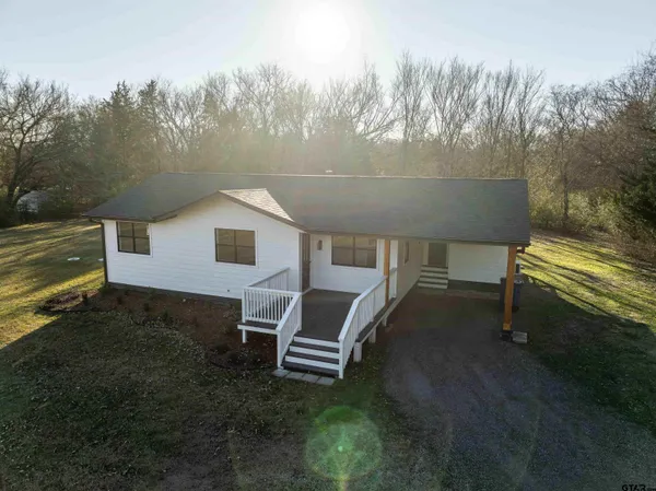 a view of a backyard with chairs