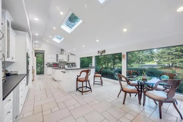 a kitchen with stainless steel appliances kitchen island granite countertop a stove a sink and a microwave