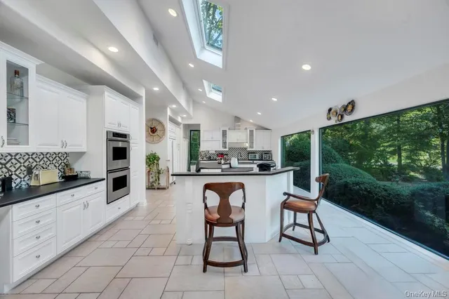 a kitchen with stainless steel appliances granite countertop a sink and cabinets