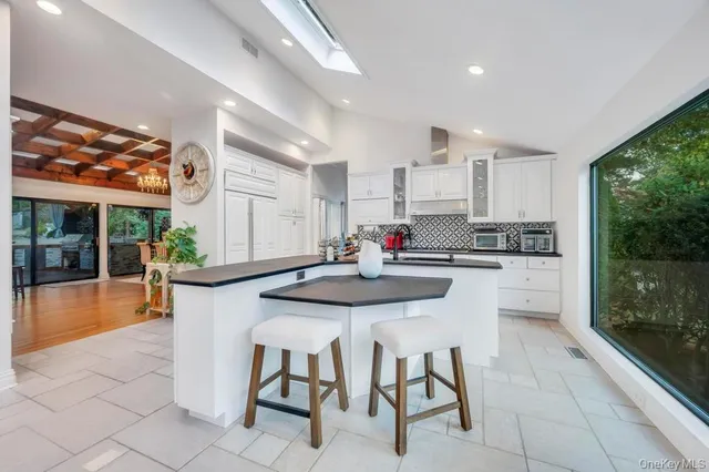 a spacious bedroom with a large bed and a large window