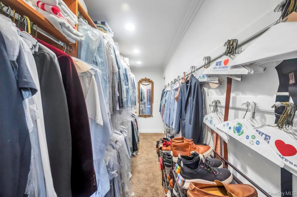 30 Fox Hollow Ridings Road Northport, NY 11768 - Photo 18 of 50 a view of walk in closet with clothes and shoes