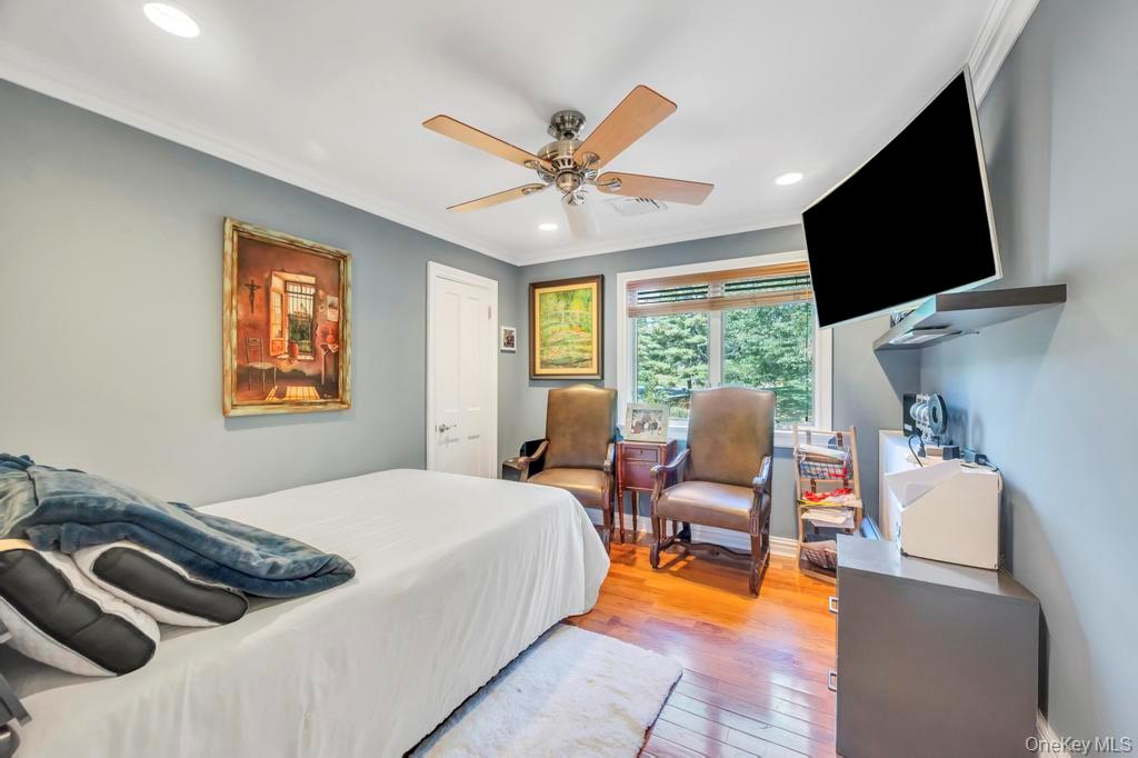 30 Fox Hollow Ridings Road Northport, NY 11768 - Photo 20 of 50 a bedroom with a bed and a flat screen tv