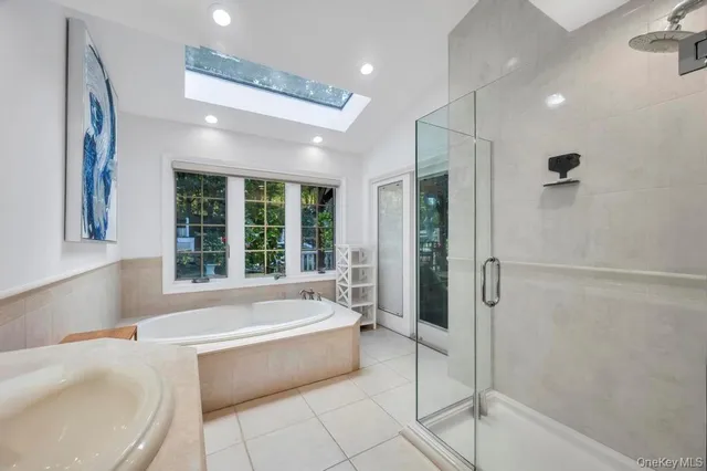 a large kitchen with kitchen island a sink a counter top space and a view of living room