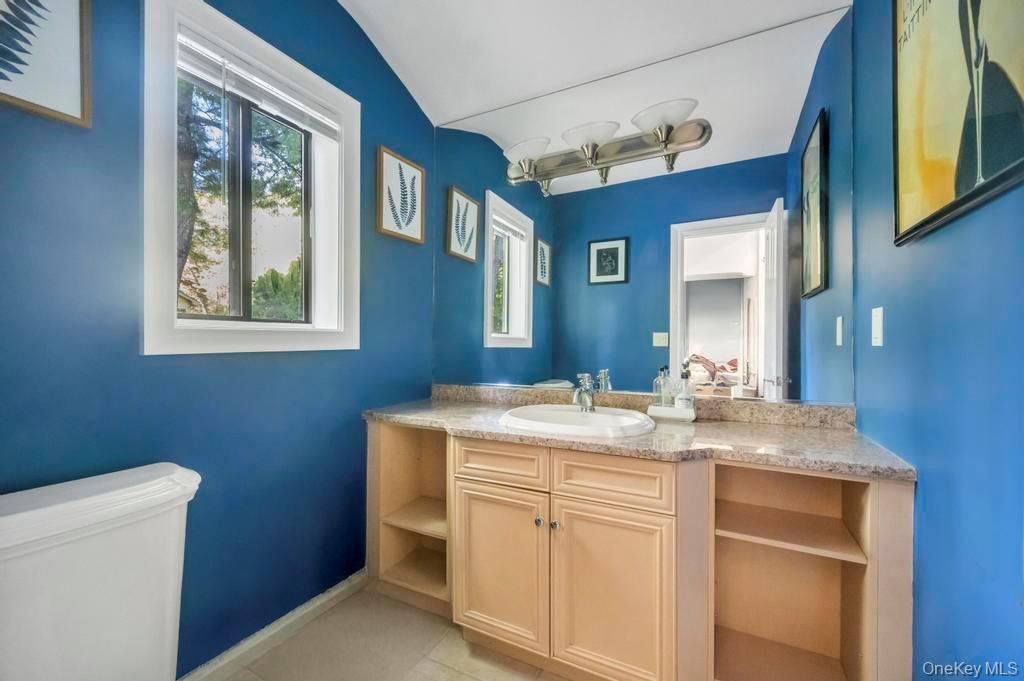 30 Fox Hollow Ridings Road Northport, NY 11768 - Photo 24 of 50 a bathroom with a granite countertop sink mirror vanity and toilet