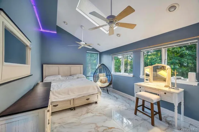 a bathroom with a granite countertop sink a toilet and a mirror