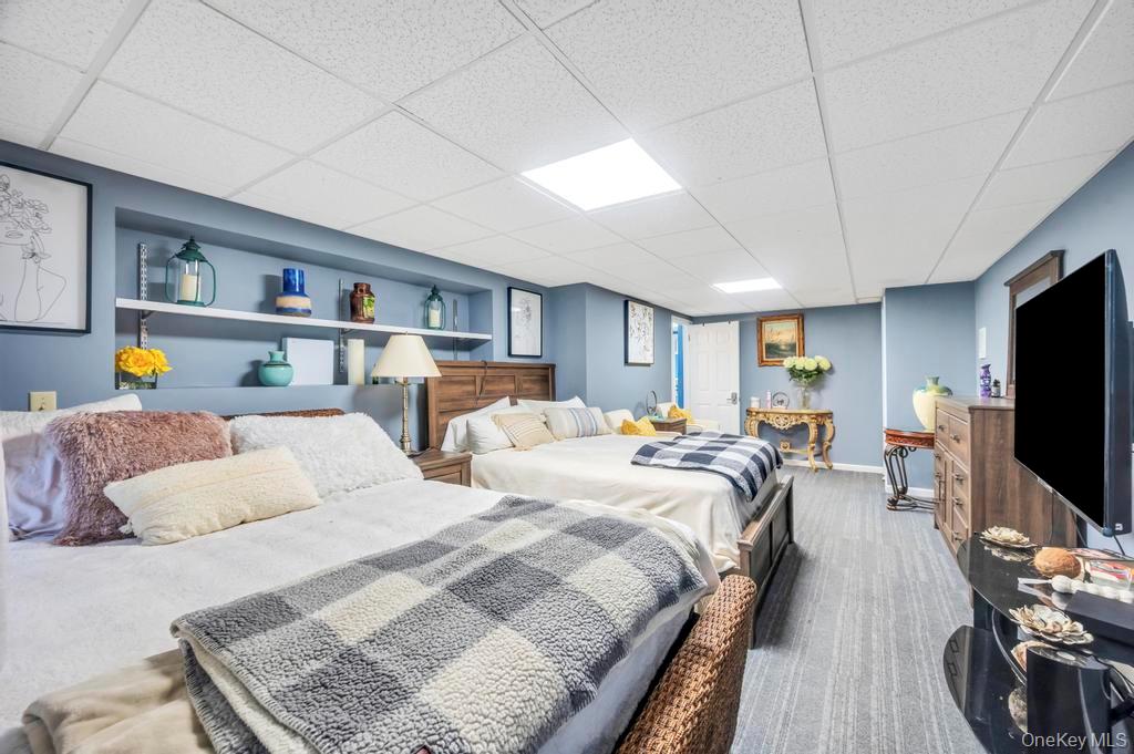 30 Fox Hollow Ridings Road Northport, NY 11768 - Photo 35 of 50 a bedroom with two beds and a flat screen tv