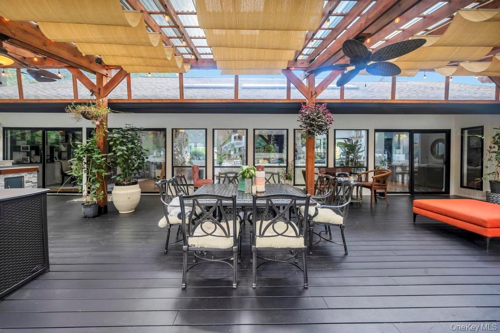 30 Fox Hollow Ridings Road Northport, NY 11768 - Photo 40 of 50 a view of a patio with a table and chairs