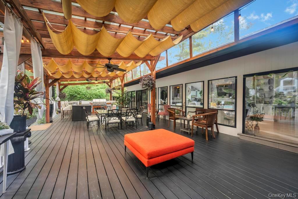 30 Fox Hollow Ridings Road Northport, NY 11768 - Photo 41 of 50 a view of a patio with table and chairs potted plants with wooden floor and fence