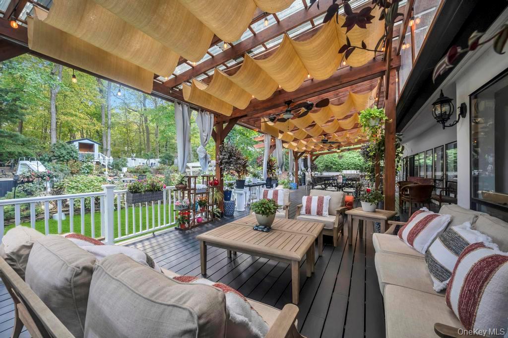 30 Fox Hollow Ridings Road Northport, NY 11768 - Photo 43 of 50 a view of a patio with a table chairs and a patio