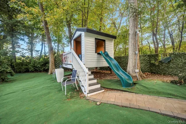 a view of house with a yard and potted plants
