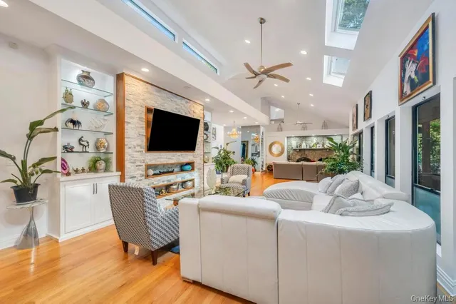 a view of a dining room with furniture a chandelier and wooden floor