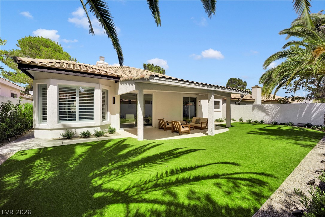 8981 Rivers Edge Drive Las Vegas, NV 89117 - Photo 45 of 69 A private yard with artificial turf and a covered patio offers ample space for outdoor enjoyment.