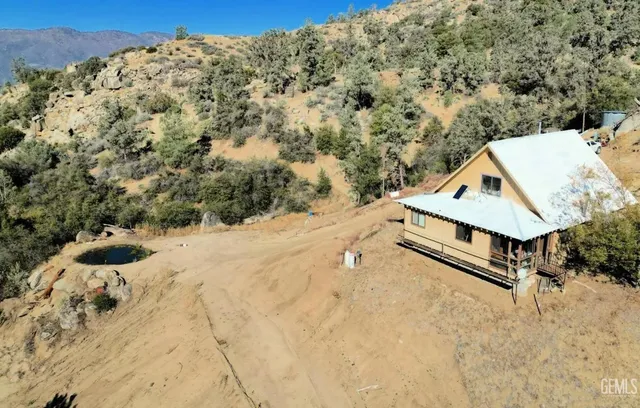 a view of a large ground with trees in the background