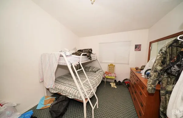a bedroom with furniture and a wooden floor