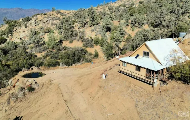 a view of a large ground with trees in the background