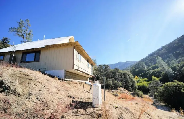 a view of a house with a snow in the background