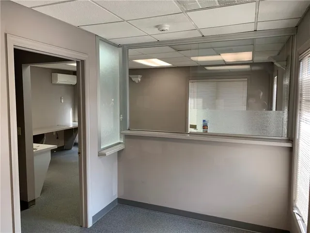 a view of room with window and a hallway