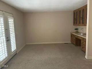 a view of an empty room with a fireplace and a window