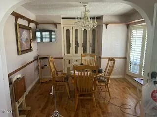 a view of a dining room with furniture and chandelier