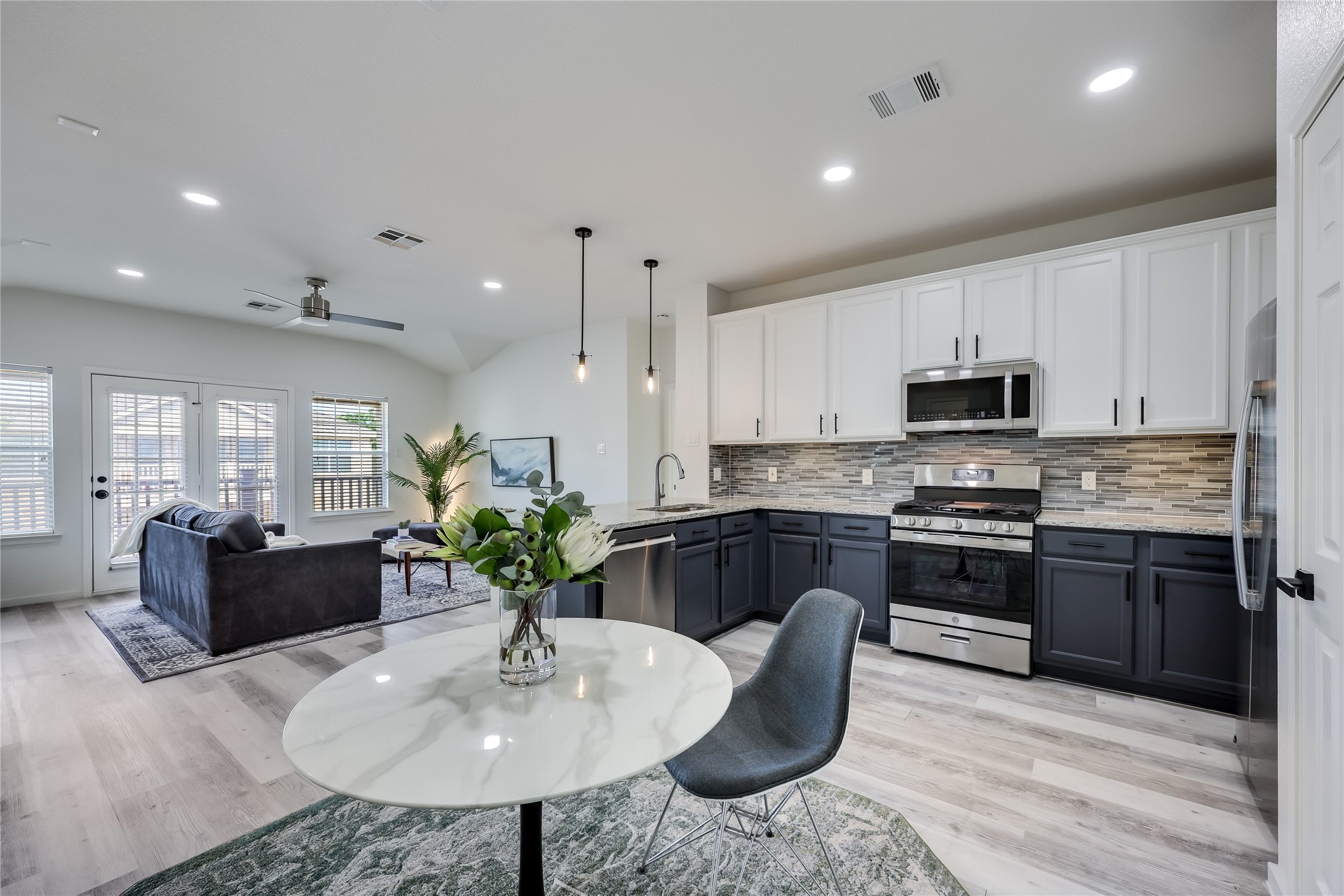 1900 Scofield Ridge Parkway, Unit 501 Austin, TX 78727 - Photo 8 of 31 a kitchen with stainless steel appliances granite countertop a stove a sink a microwave a dining table and chairs