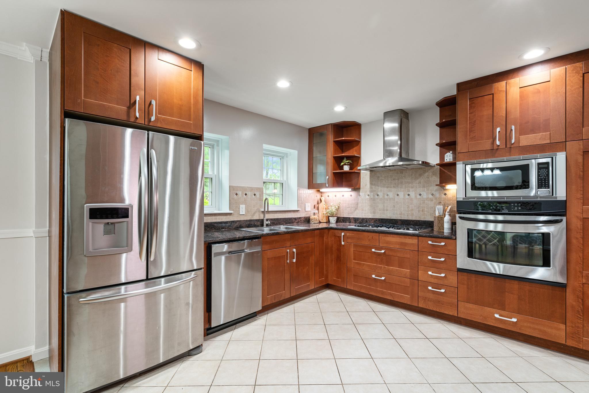2192 Golf Course Drive Reston, VA 20191 - Photo 13 of 125 a kitchen with stainless steel appliances granite countertop a refrigerator and a stove top oven