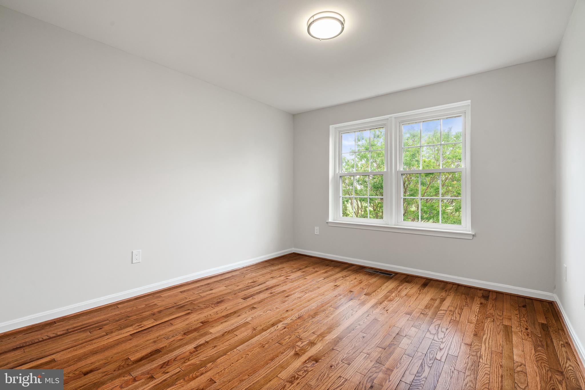 2192 Golf Course Drive Reston, VA 20191 - Photo 21 of 125 an empty room with wooden floor and windows