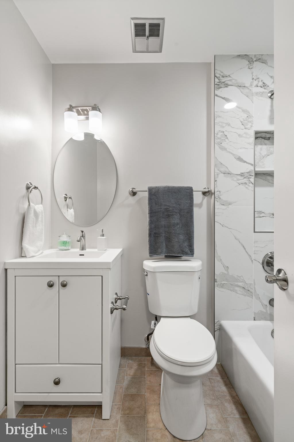 2192 Golf Course Drive Reston, VA 20191 - Photo 25 of 125 a bathroom with a toilet a sink a mirror a bathtub and vanity