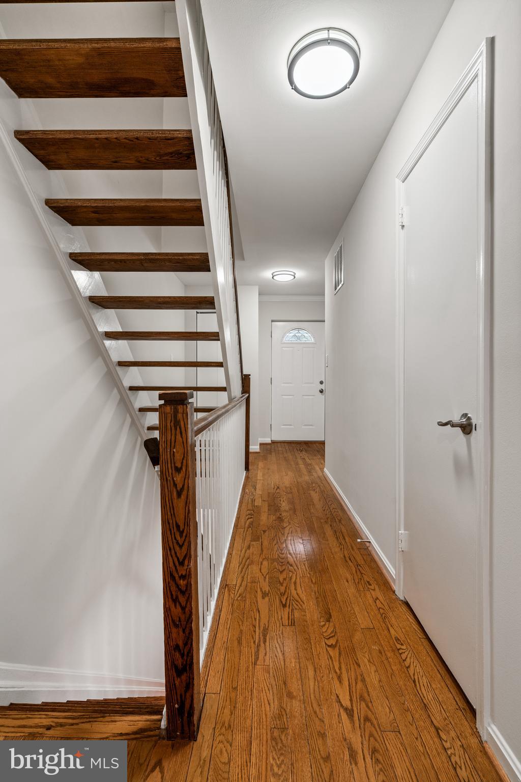 2192 Golf Course Drive Reston, VA 20191 - Photo 27 of 125 a view of a hallway with wooden floor and staircase