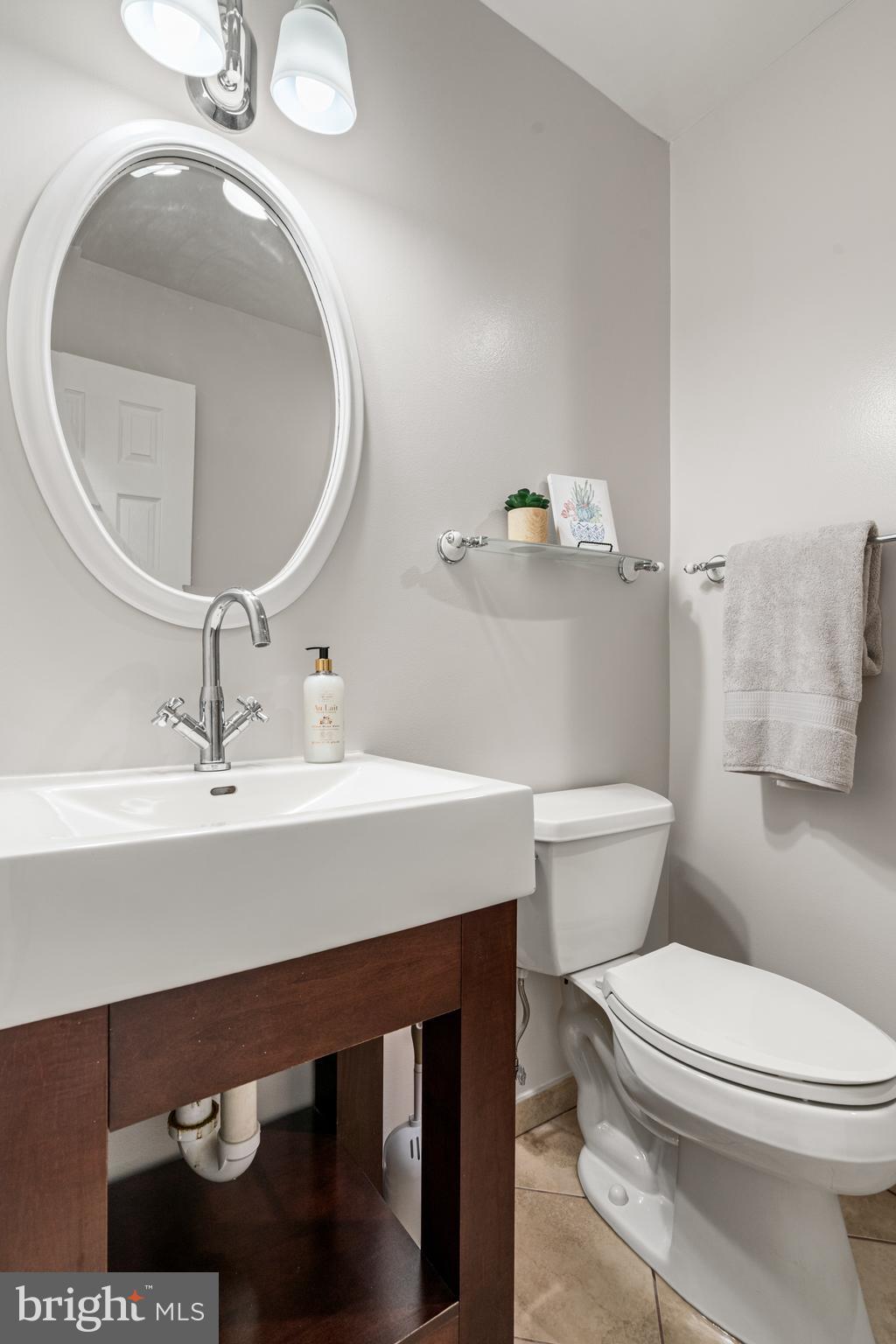 2192 Golf Course Drive Reston, VA 20191 - Photo 35 of 125 a bathroom with a sink a toilet and a mirror