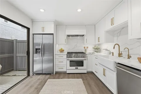a kitchen with white cabinets and white appliances