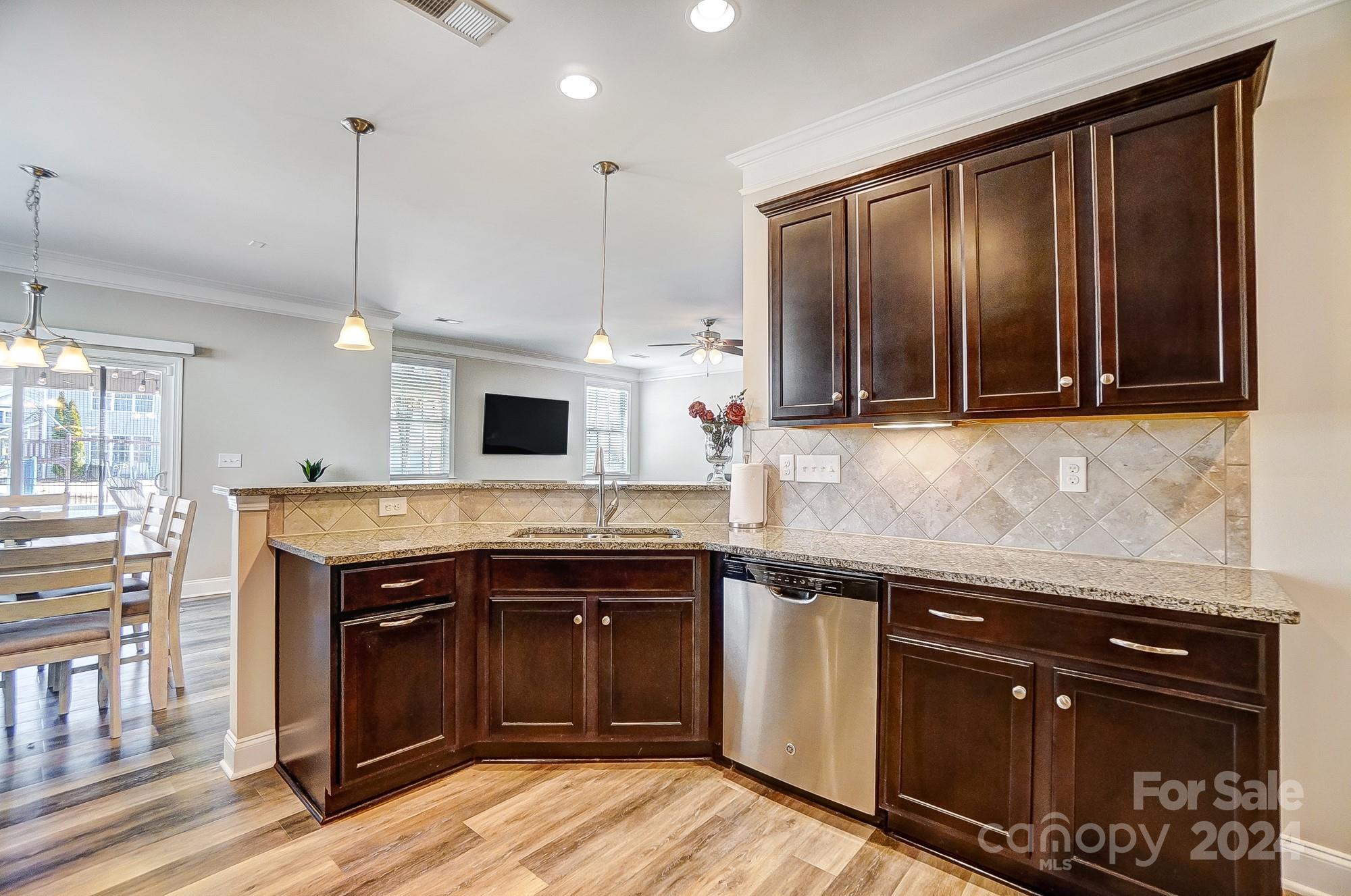 156 Annatto Way Tega Cay, SC 29708 - Photo 13 of 48 a kitchen with a sink stove and cabinets