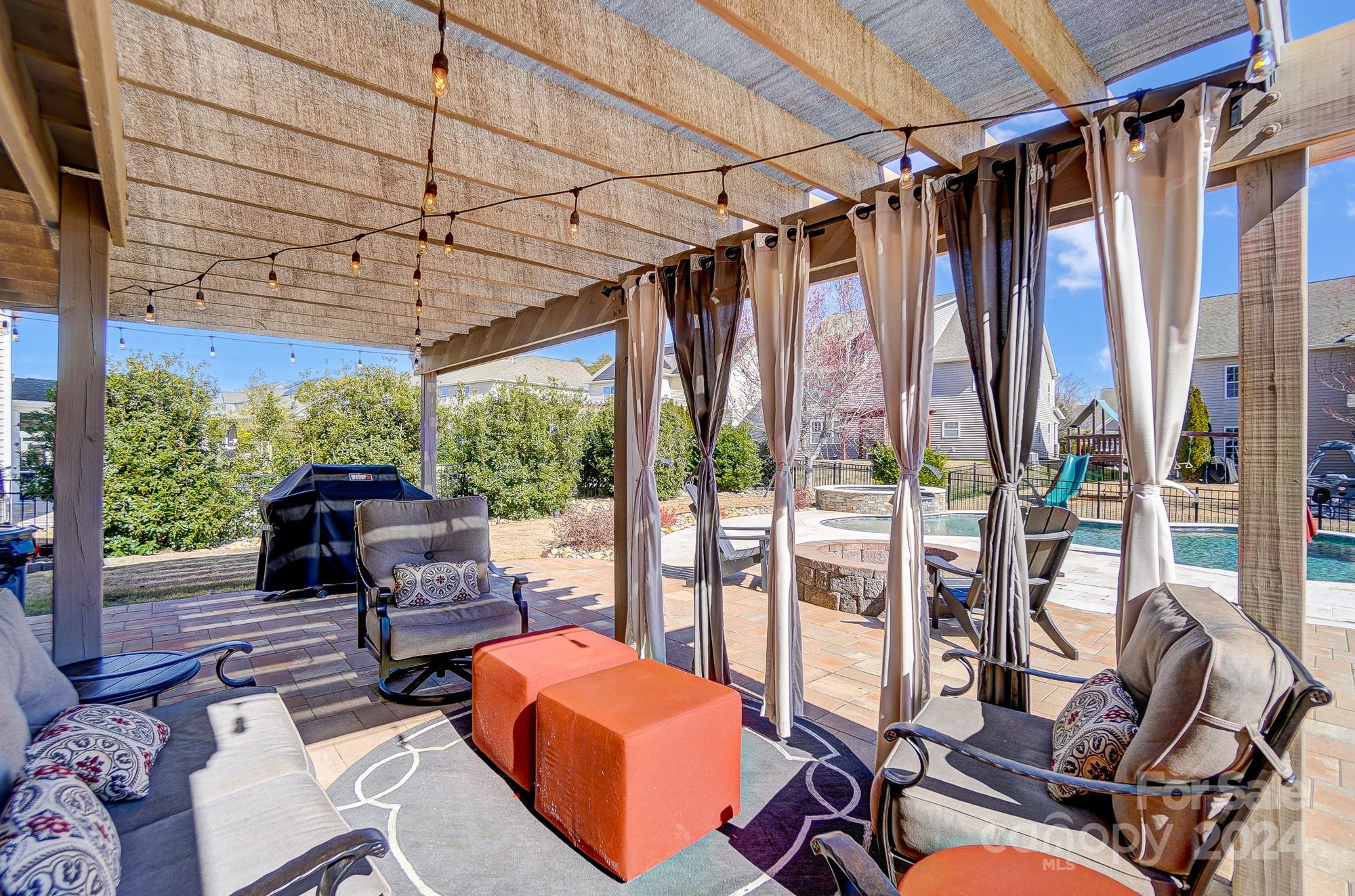 156 Annatto Way Tega Cay, SC 29708 - Photo 22 of 48 a outdoor space with the couches and dining table with the garden view