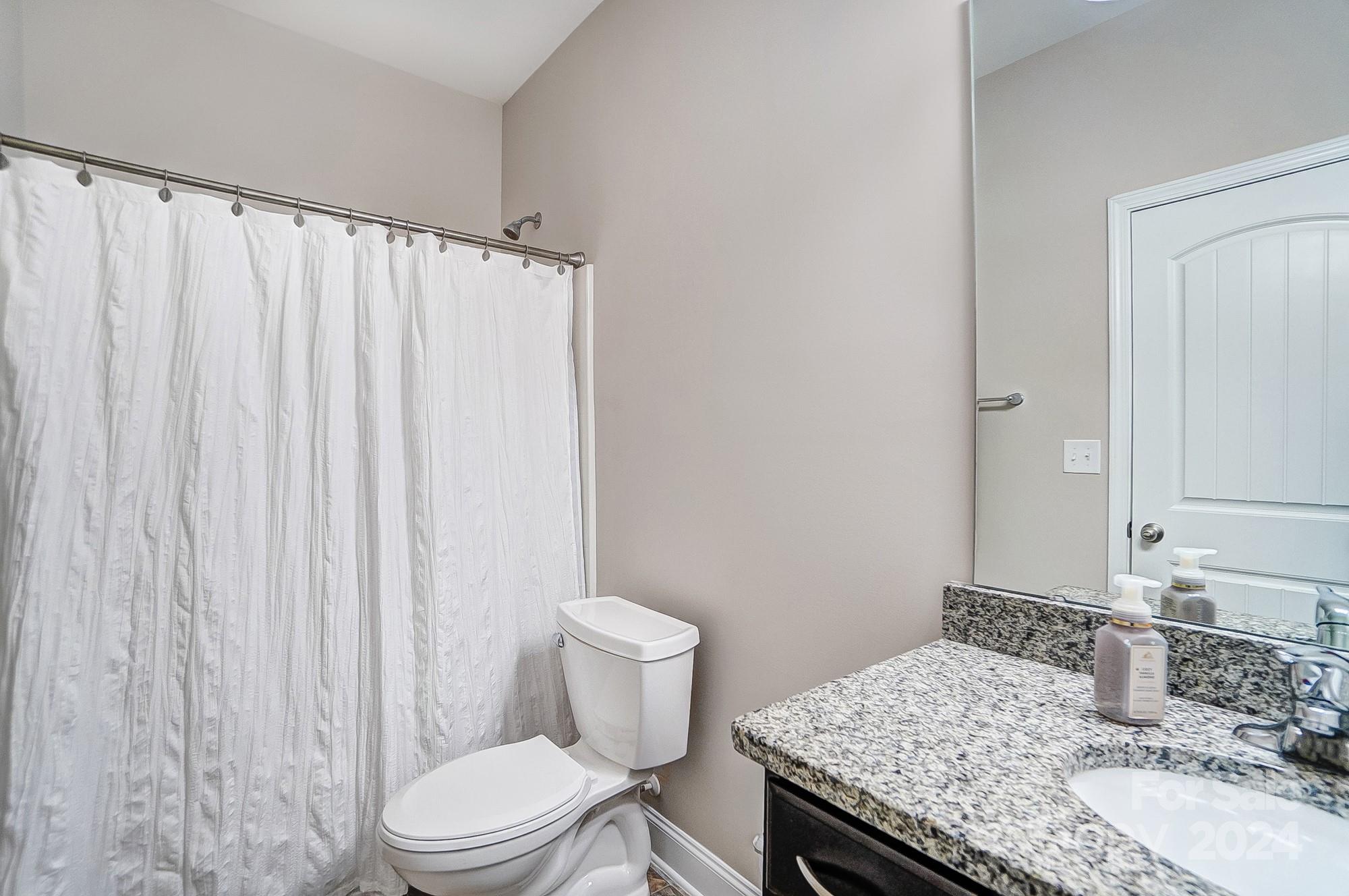 156 Annatto Way Tega Cay, SC 29708 - Photo 37 of 48 a bathroom with a granite countertop sink toilet and a mirror