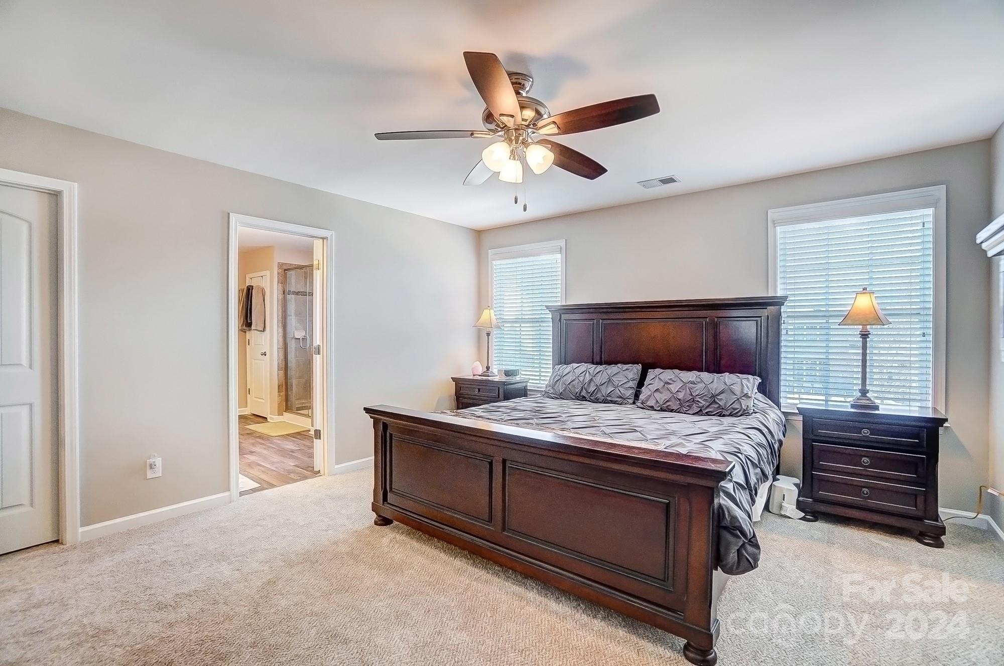 156 Annatto Way Tega Cay, SC 29708 - Photo 39 of 48 a bedroom with a bed and a ceiling fan