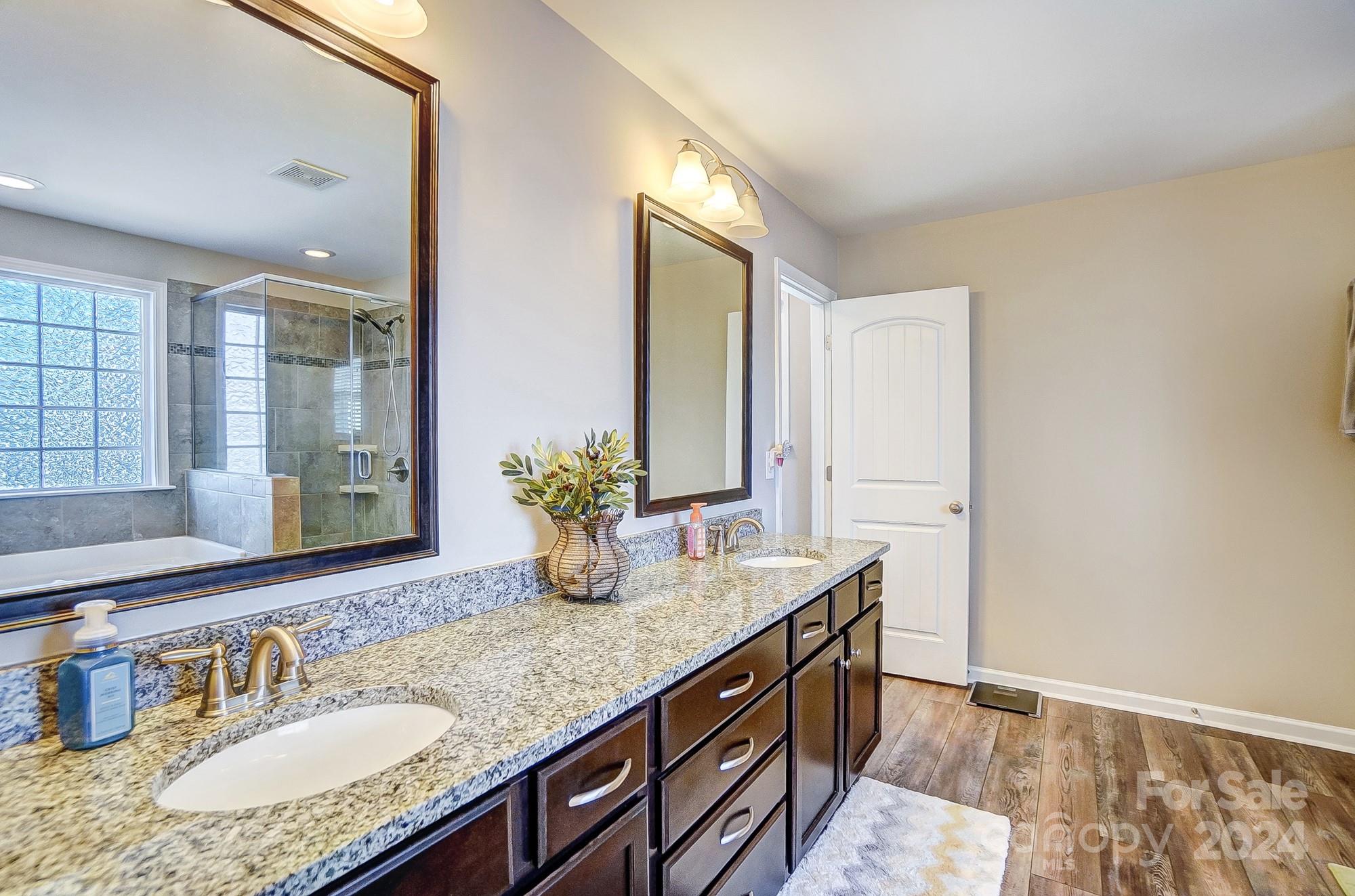 156 Annatto Way Tega Cay, SC 29708 - Photo 40 of 48 a bathroom with a granite countertop sink and a mirror