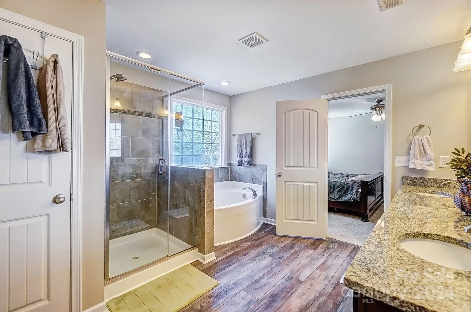 156 Annatto Way Tega Cay, SC 29708 - Photo 41 of 48 a bathroom with a granite countertop tub sink and glass door