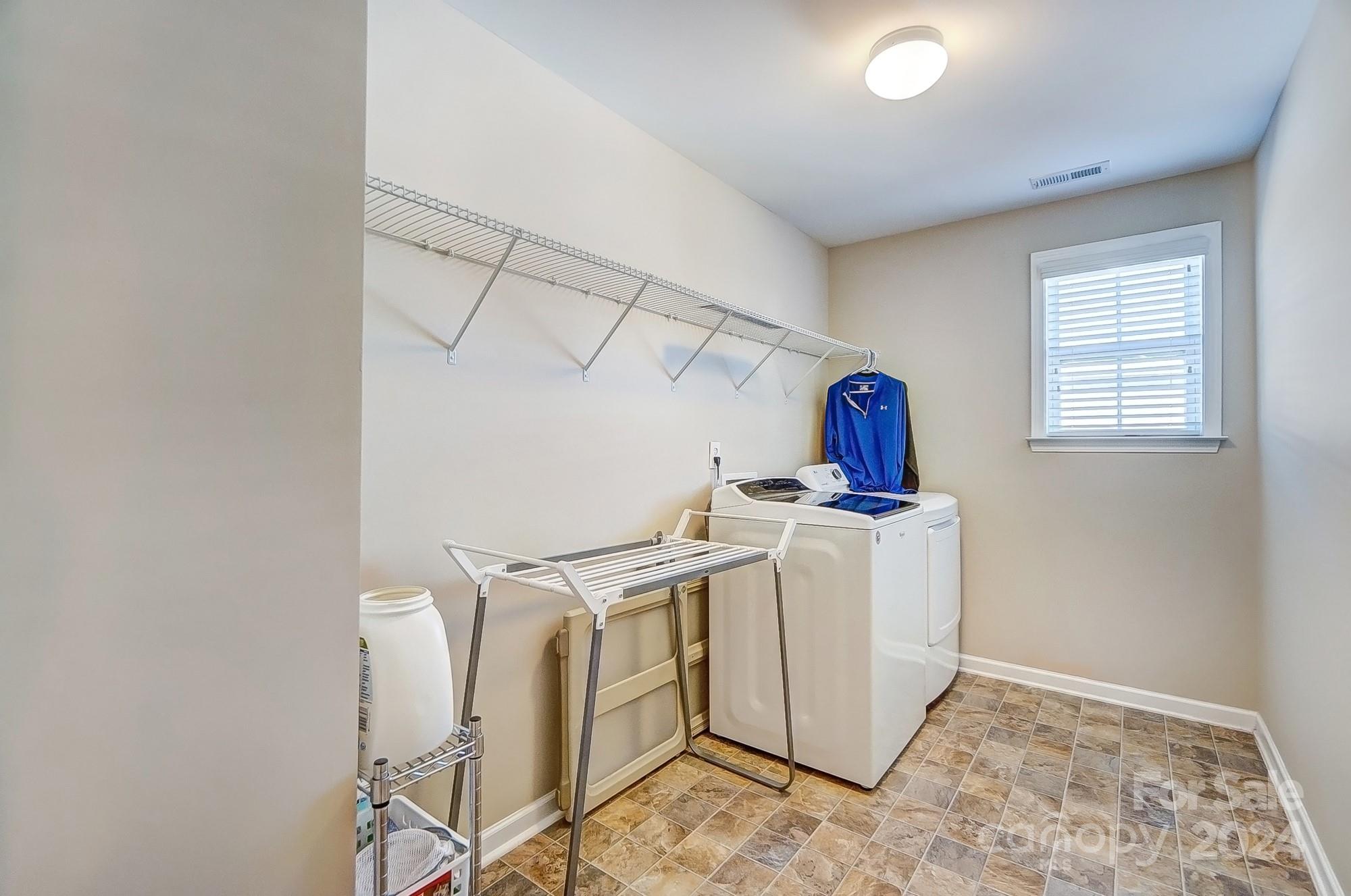 156 Annatto Way Tega Cay, SC 29708 - Photo 43 of 48 a view of a storage & utility room with dryer and washer