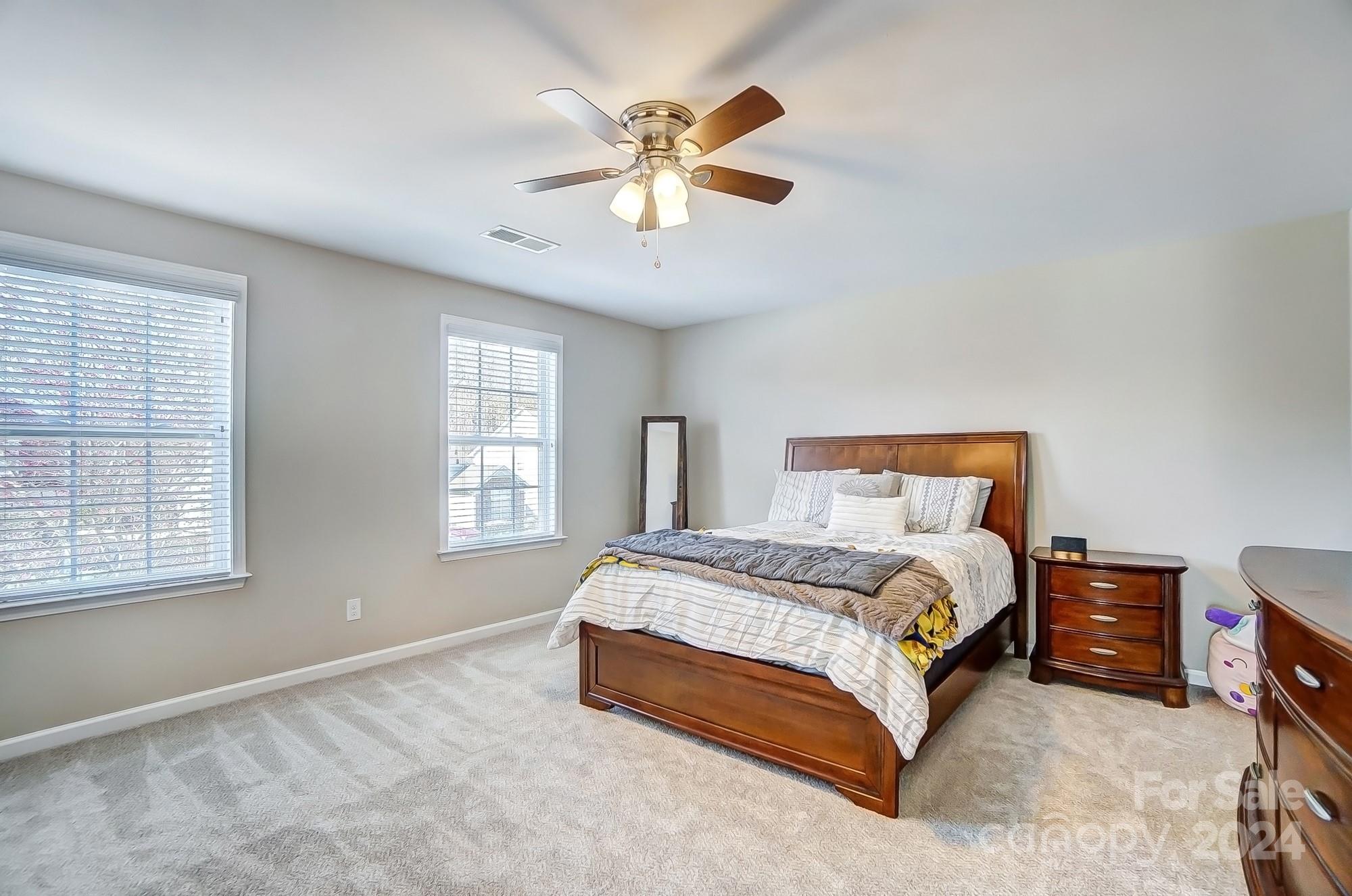 156 Annatto Way Tega Cay, SC 29708 - Photo 44 of 48 a spacious bedroom with a bed and window