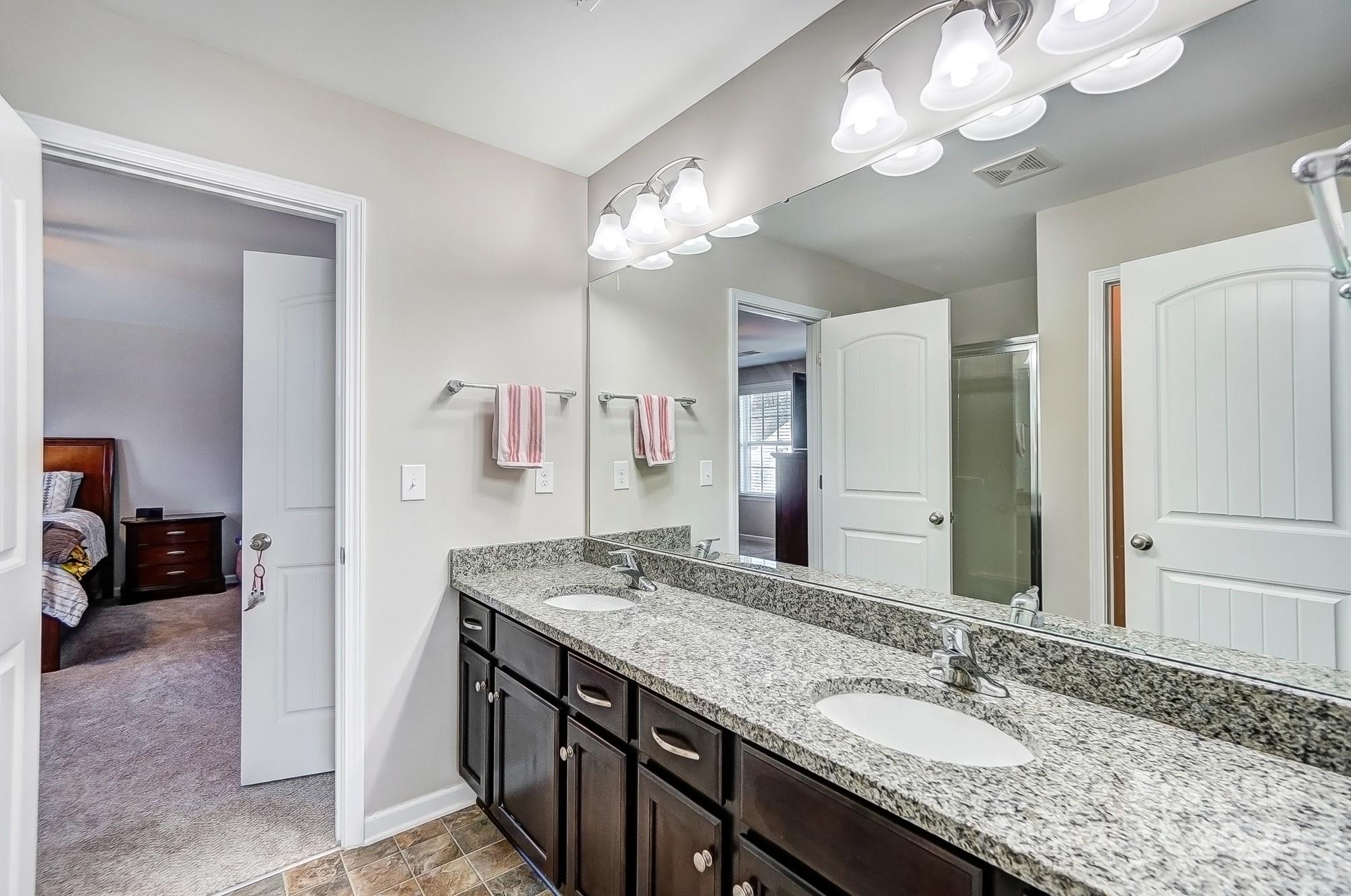 156 Annatto Way Tega Cay, SC 29708 - Photo 45 of 48 a bathroom with a granite countertop double vanity sink and a mirror