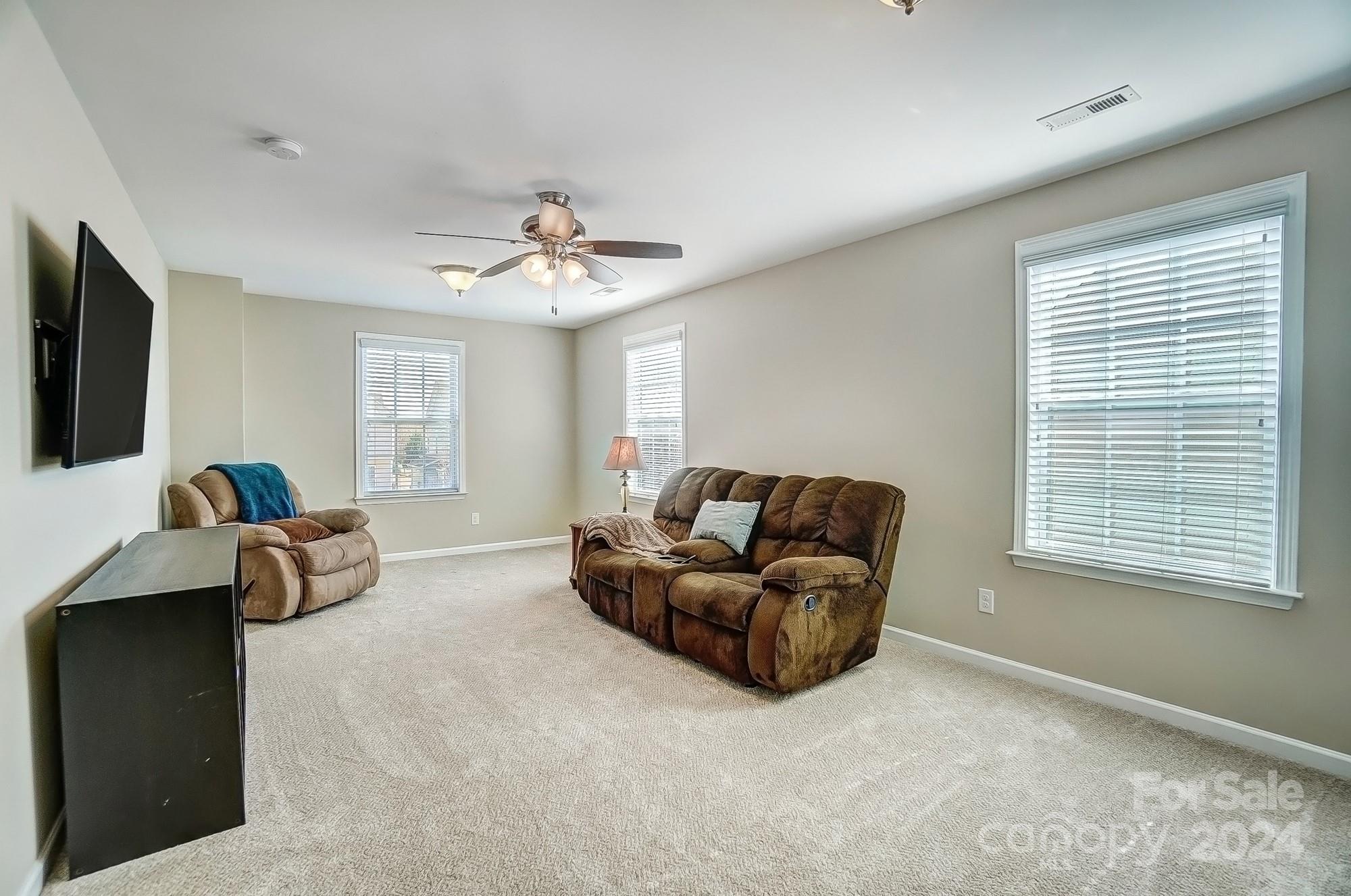 156 Annatto Way Tega Cay, SC 29708 - Photo 48 of 48 a living room with furniture and a flat screen tv