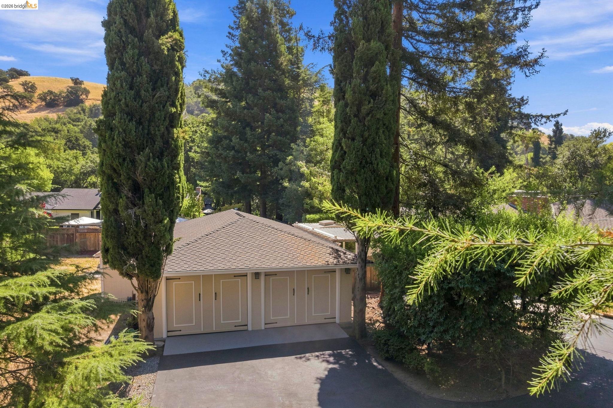 5075 Alhambra Valley Road Martinez, CA 94553 - Photo 56 of 68 Attached three-car garage with panel doors and a paved driveway