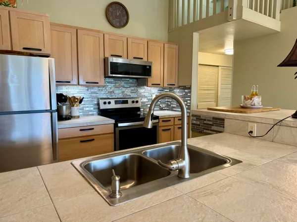 a kitchen with a refrigerator and a sink