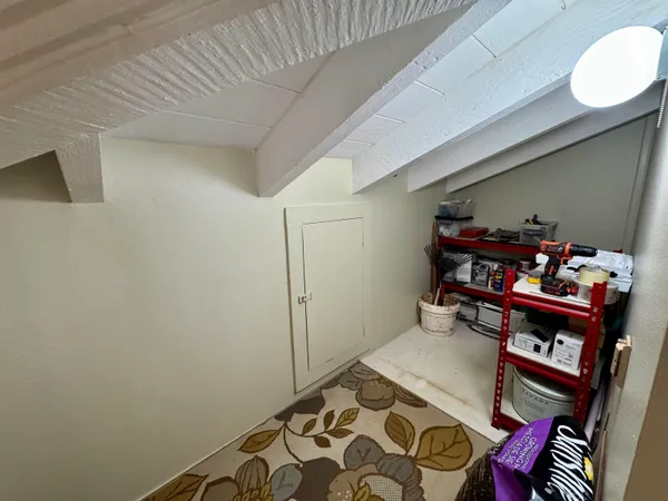 a view of a livingroom with furniture and floor to ceiling window
