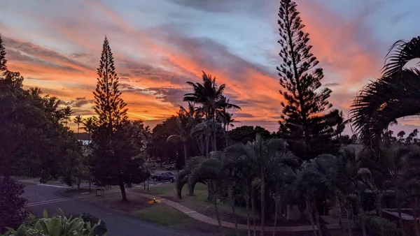 a living room with a couch and a chandelier
