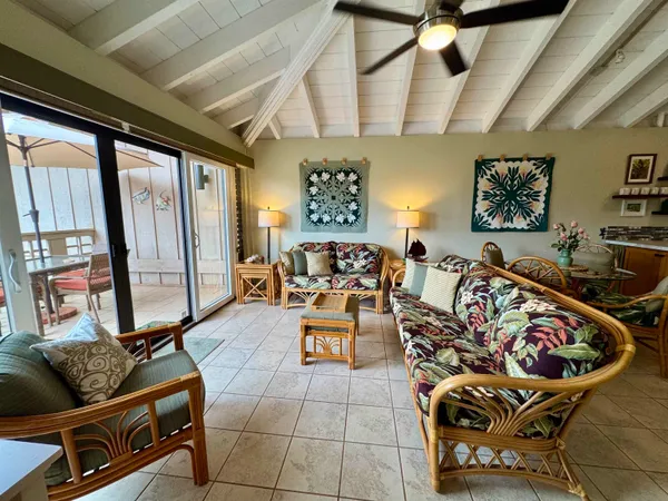 a living room with furniture and a floor to ceiling window