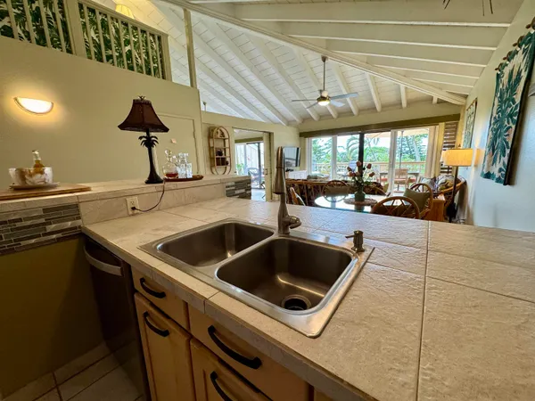 a kitchen with stainless steel appliances a refrigerator sink and microwave