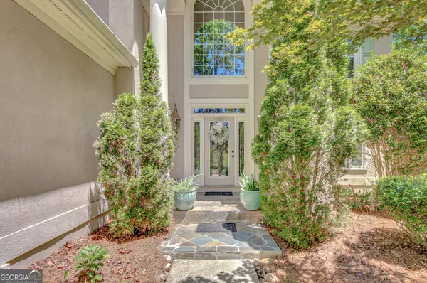 a front view of a house with a garden